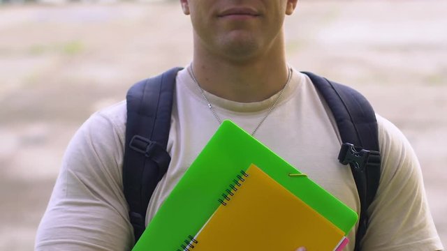 Handsome cadet holding books, military education and training, career in army