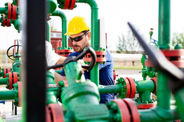 Engineer, working with pipeline controls inside oil and gas refinery