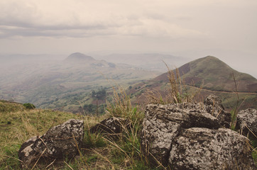 The Ring Road in Cameroon, Africa with soft hills in background and large rocks in foreground on...