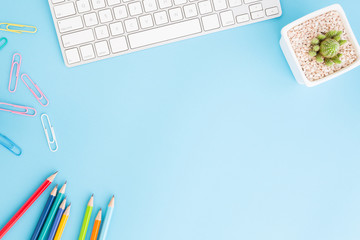 Flat lay photo of office desk with pencil and keyboard ,Top view workpace on blue background and copy space