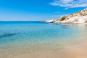 Crystal blue waters on Mikri Vigla beach on Naxos island, one of the most beautiful beaches of the Aegean Sea. Cyclades, Greece - obrazy, fototapety, plakaty