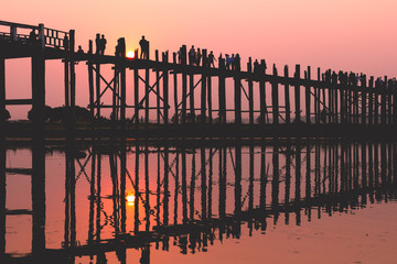People on the bridge at sunset on an exciting journey