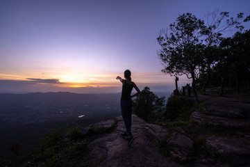Woman successful hiking climbing silhouette in mountains