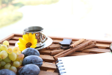 Coffee delicious aroma in the morning with fruits and outdoors with a notepad for notes