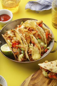 Overhead image of mexican tacos with chili con carne and grated cheese