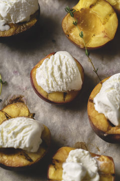 Close up of grilled peaches and nectarines served with vanilla ice cream