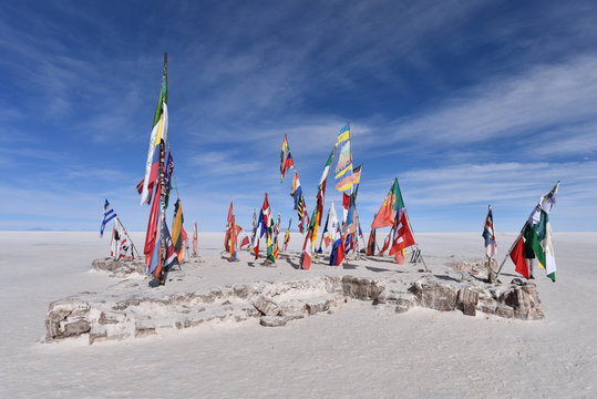 Flags of the world flying outside the Playa Blanca salt hotel on the Salar de Uyuni, Bolivia