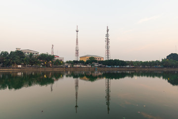 Telecommunication tower and the reflection at a riverside.