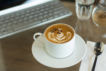 Coffee cup on wood table at work office,selective focus.