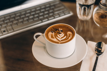 Coffee cup on wood table at work office,selective focus.
