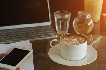 Coffee cup on wood table at work office,selective focus.