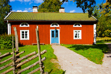 traditional Swedish red and white house or tiny cottage on the countryside 