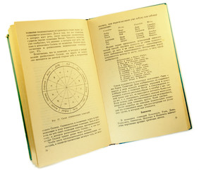 Naklejka premium An old astronomical book with yellowed pages, in Russian. Isolated on white background.