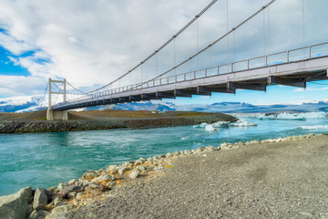 Metal bridge cross the river that flowing from Jokulsarlon glacier lagoon, Iceland
