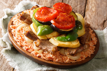 Summer Arabic dinner rice with beef, eggplant, pepper, onions and tomatoes close-up. Horizontal