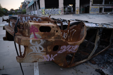 Wasted car in abandoned car dealership