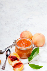 Homemade peach jam with organic fruit. Sweet preserves on a light background, , copy space