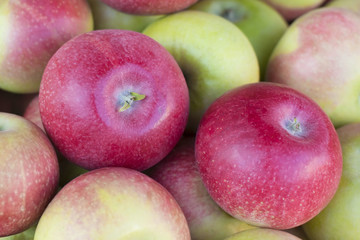 juicy ripe pink apples in a box with apples