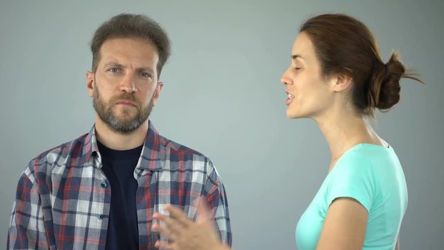 Man showing stop sign to annoyed wife who constantly screaming and complaining