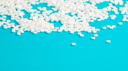 Sugar pills blue background. Medical pills close-up