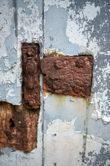 Rusty hinge of old building door