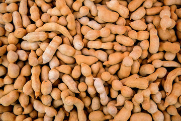 Pile of ripe Tamarind fruits.Sweet ripe tamarinds. Tamarind fruit Background. A big pile of tamarinds use for background or wallpaper.