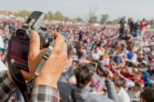 Camera Man Taking Photos with Digital DSLR Camera