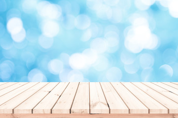 Wood plank with abstract blue blurred bokeh background for product display