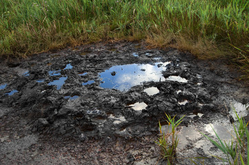 Spills of crude oil on the soil surface - environment pollution.