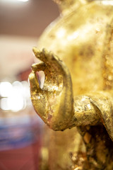 The golden Buddha statue.View of buddha statue in Thailand.Close up hand of statue Buddha.buddhism concept