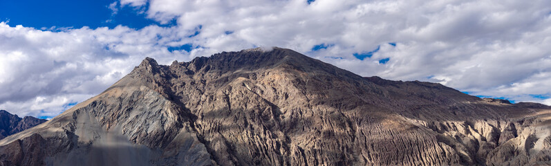 Panorama of Nubra Valley Rock mountains with Cloudy Dark sky in Summer, Leh Ladakh, Jammu and Kashmir, India