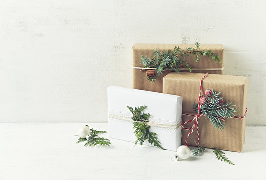 Christmas presents decorated with natural evergreen twigs. Copy space