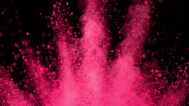 Super slowmotion shot of color powder explosions isolated on black background. Shot with high speed cinema camera at 1000fps