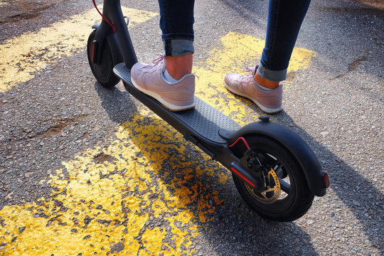 Electric Scooter On A Road, Girl Riding Scooter