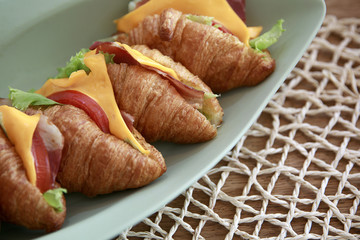 Delicious croissant sandwich on table, closeup