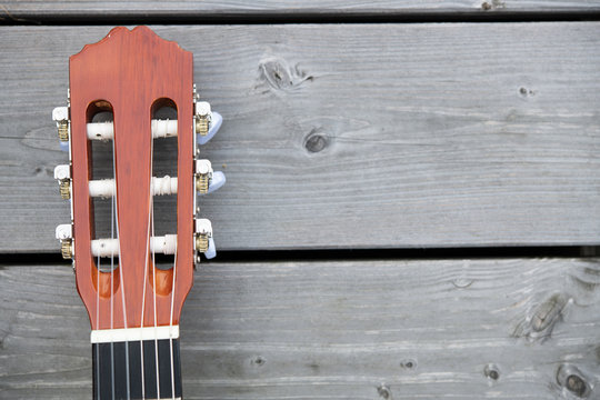 acoustic guitar neck on wooden ground