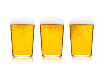 Cold glasses of lager beer with foam and dew