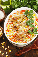 Chicken legs baked with rice and vegetables