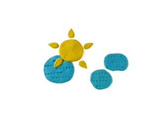 Beautiful sky made from plasticine clay on white background, cute yellow sun and blue cloud shaped dough  