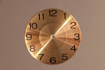 The  round watch face no clock hands on grey background. Blank clock face without hour, minute and second hands.