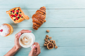 Coffee and cake for breakfast, top view, space for advertising