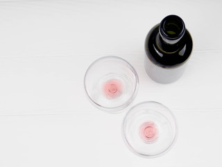 Wine glass and Bottle on a wooden background, bottle of red wine and glasses lying on an old wooden...