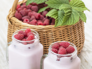 Raspberry yogurt on a wooden table. 
