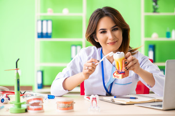 Woman dentist working on teeth implant