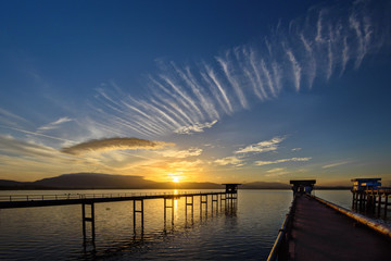 Fototapeta na wymiar The bridge into the lake with sunrise sky