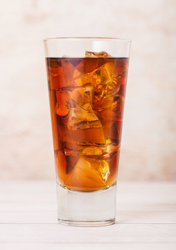 Glass of fresh summer ice tea drink with ice cubes