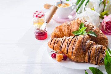 Fresh Croissant with berries and jam for breakfast isolated on white wooden background , copy space