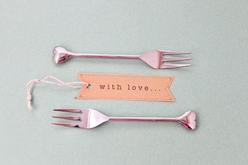 two heart shape forks with a with love tag.ideal wedding gift