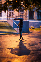 beautiful girl with umbrella in the evening