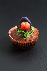 Halloween Holiday food colorful fancy brownies cupcake with gravestones and pumpkin fondant decorate